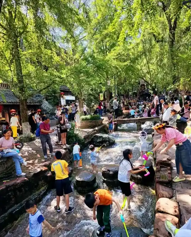 Playing in the water at Huanglongxi Ancient Town